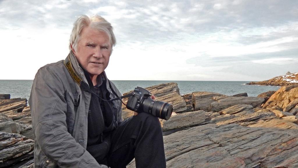 Photo of David Evans Shaw against rocks and the ocean